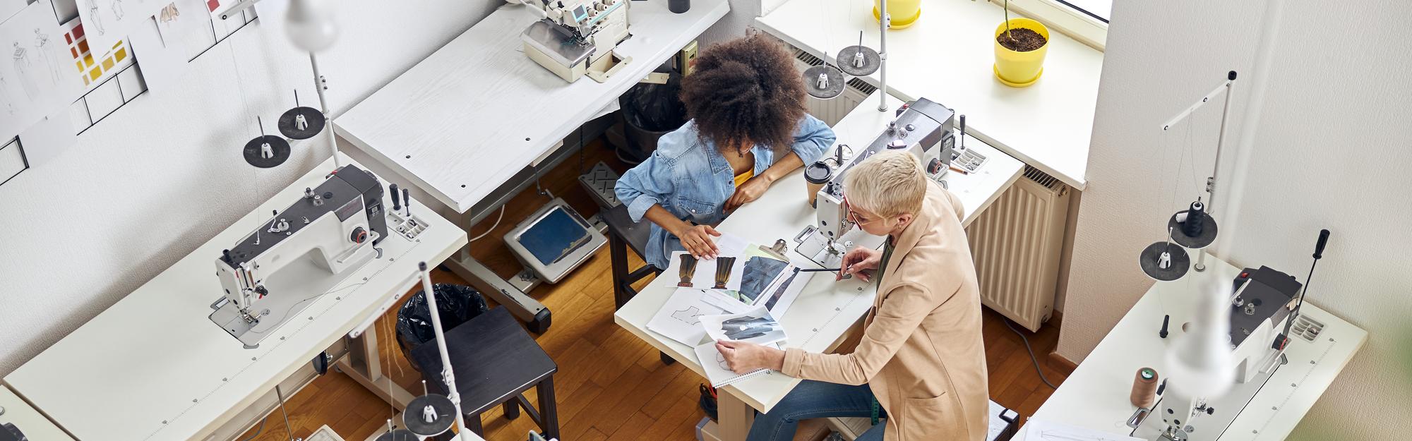 Workshop interior with embroidery machines and floating panels